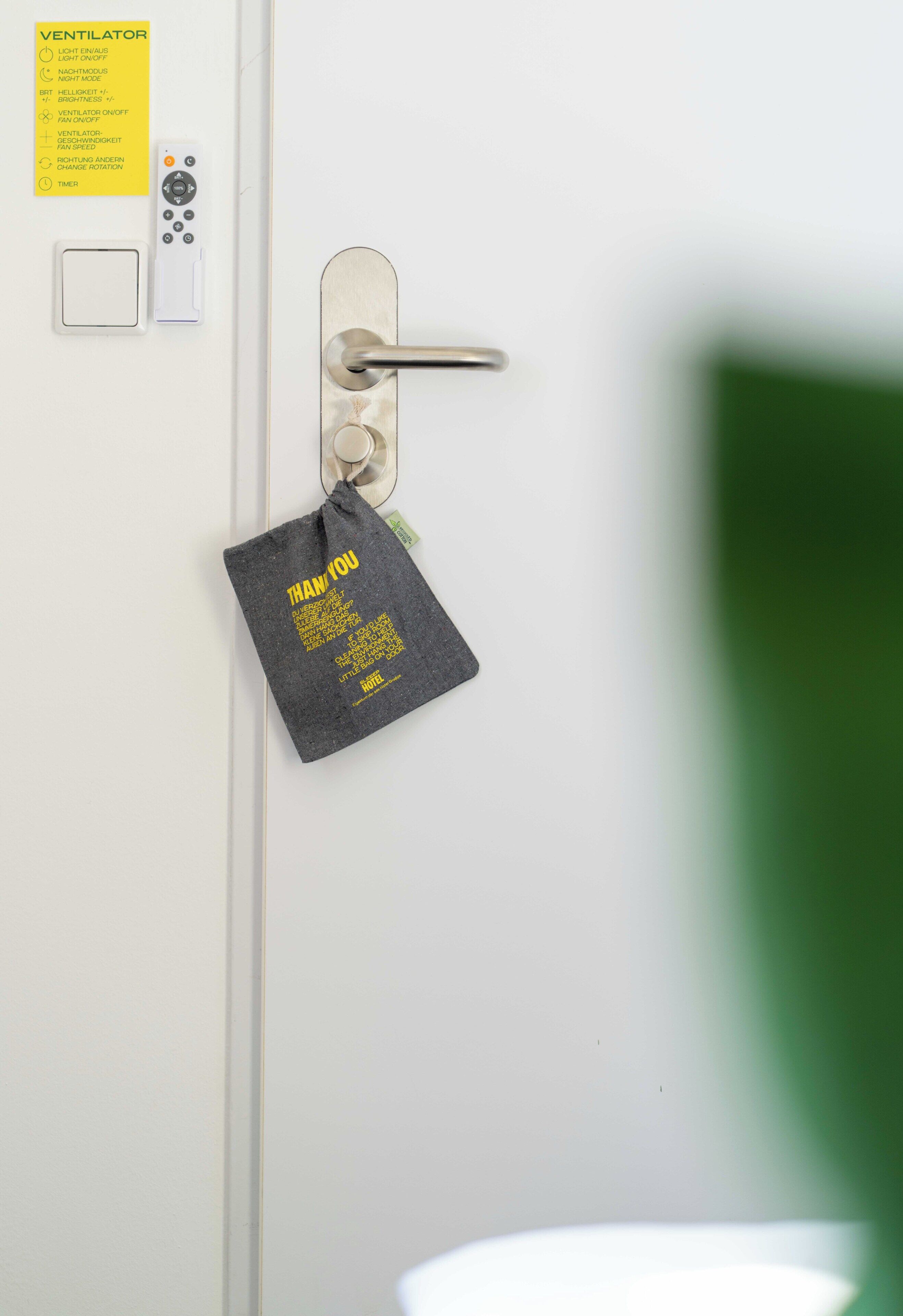 A door with a lock, a keycard reader, a control panel, and a thank you note.