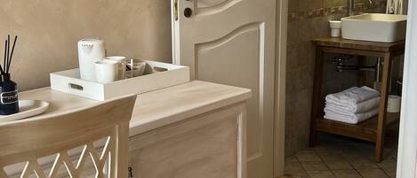 A bathroom with a wooden vanity, a sink, and a mirror.