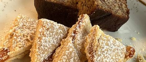 A loaf of bread and triangular pastries on a plate.