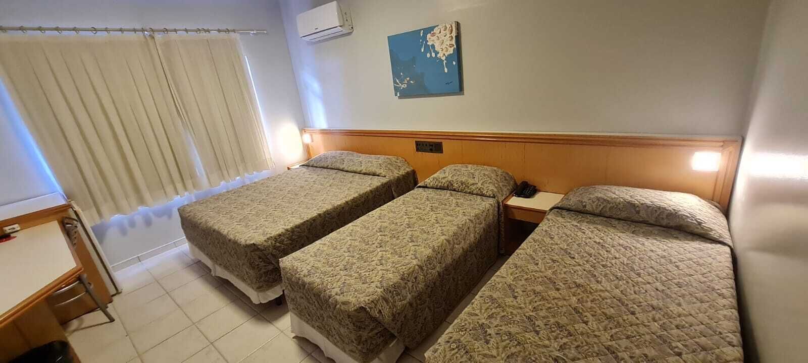 Standard Quadruple Room | Minibar, in-room safe, desk, laptop workspace