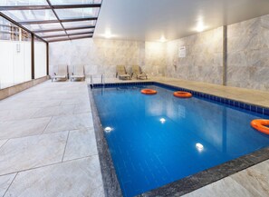 Una piscina cubierta, una piscina al aire libre