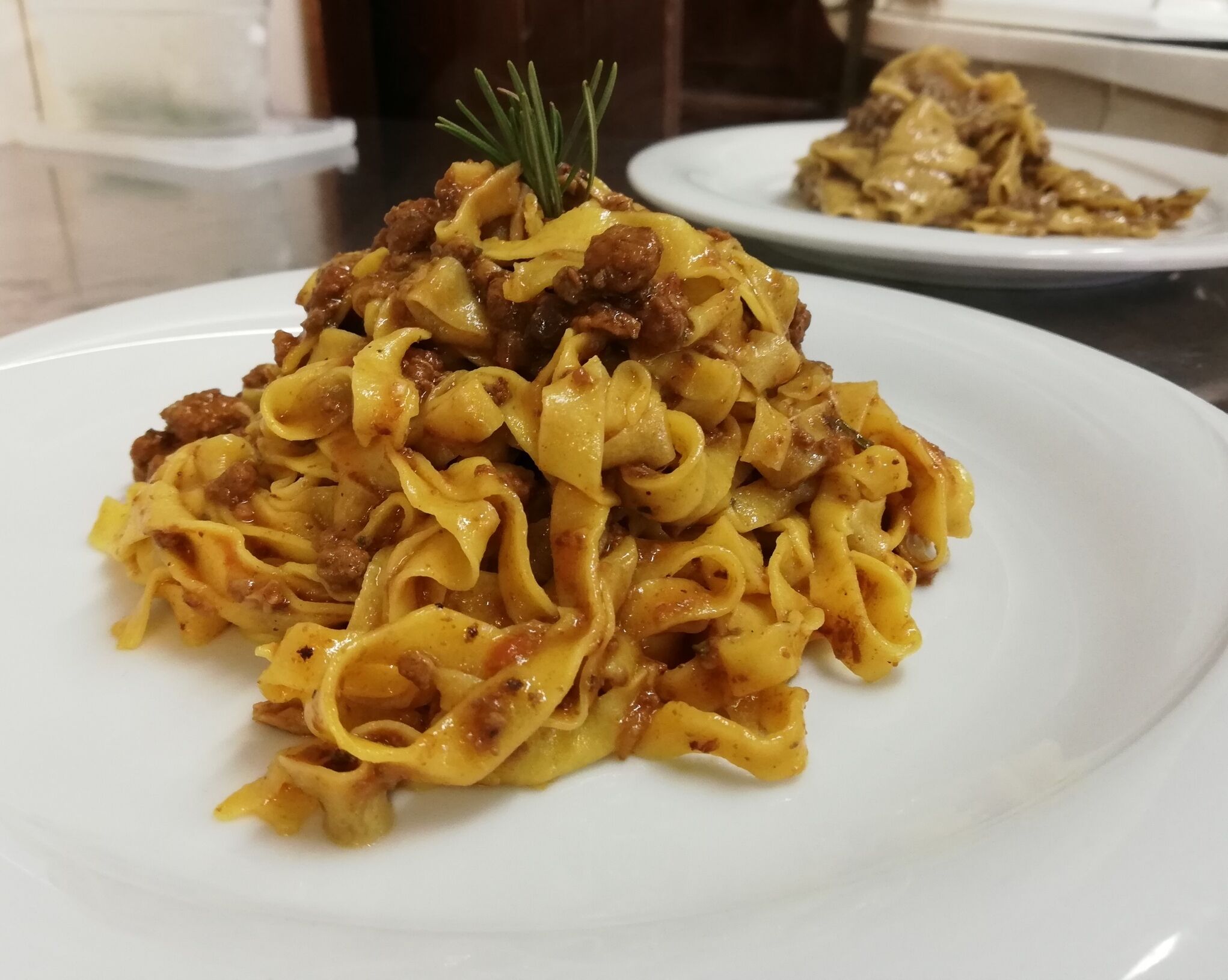 Ein Teller Pasta mit Rosmarinzierde.
