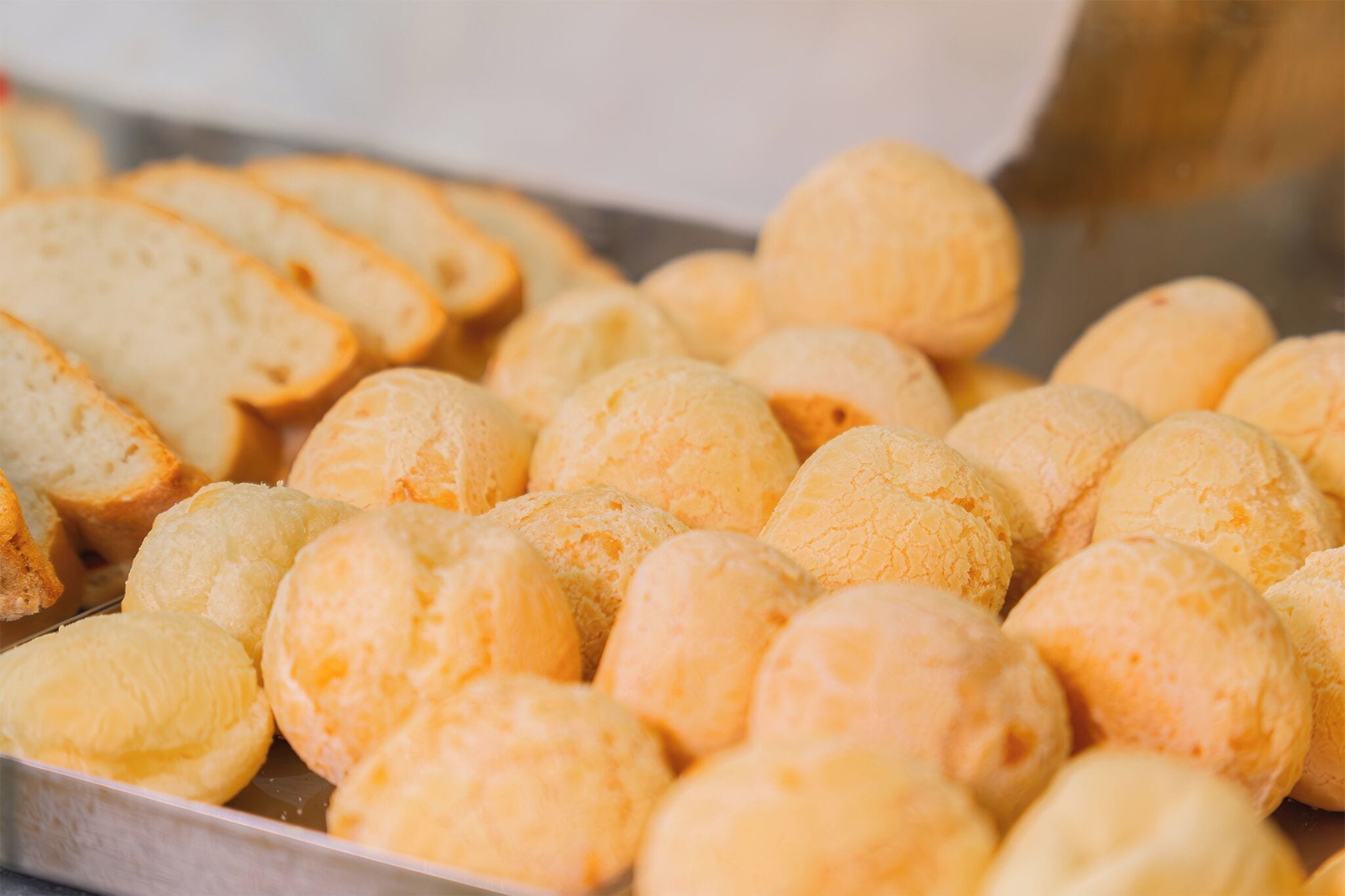 A tray of round, yellow pastries.