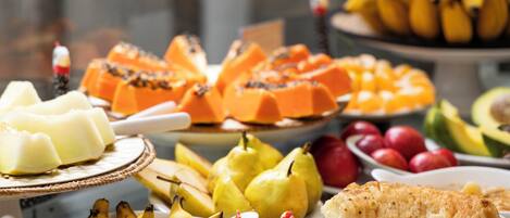 A variety of fruits and desserts on a table.