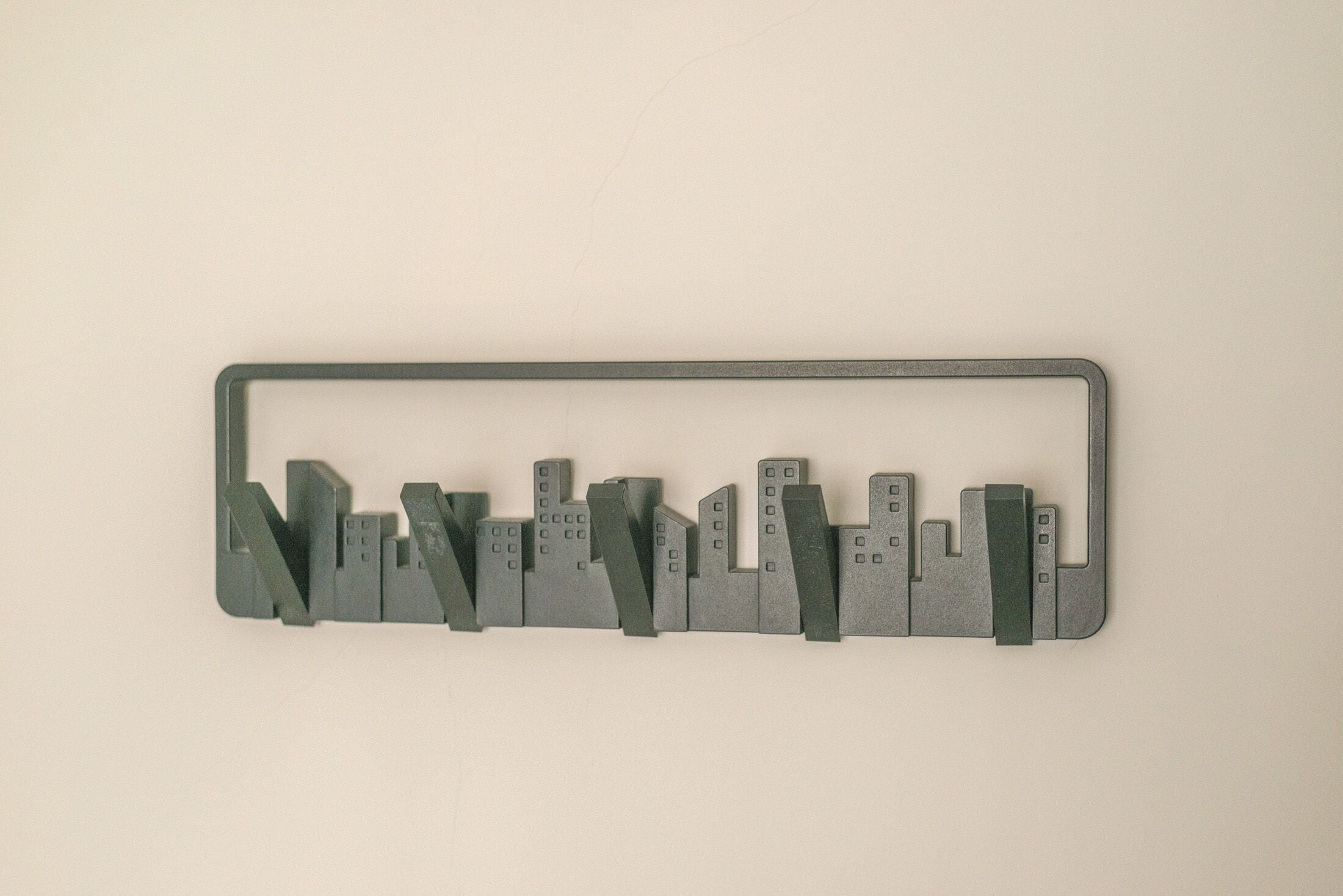 A gray metal frame with a cityscape design.