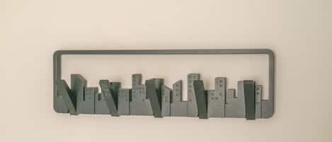 A gray metal frame with a cityscape design.