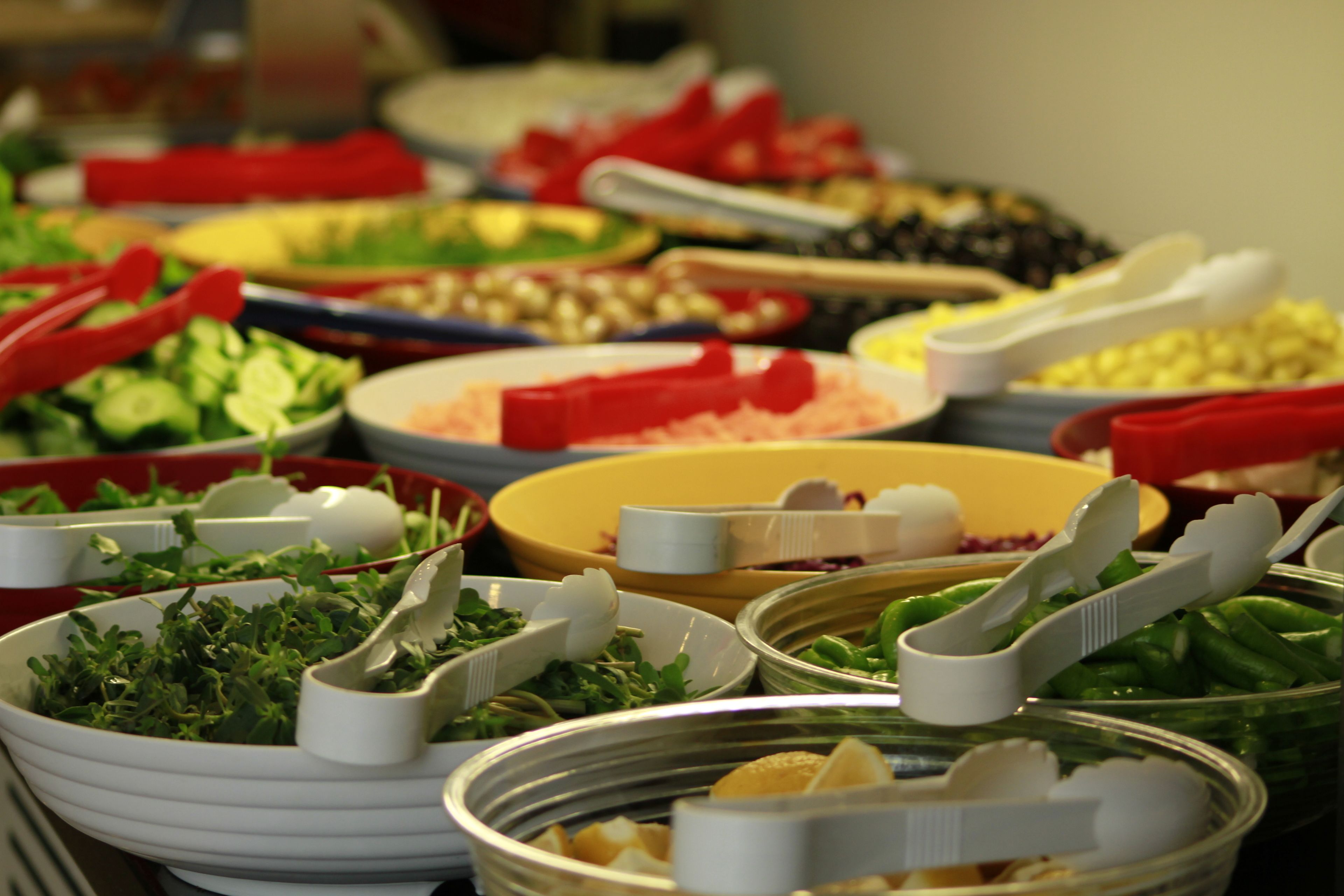 A buffet with various dishes and utensils.