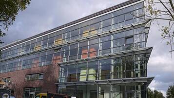 A modern building with large glass windows and a brick facade.