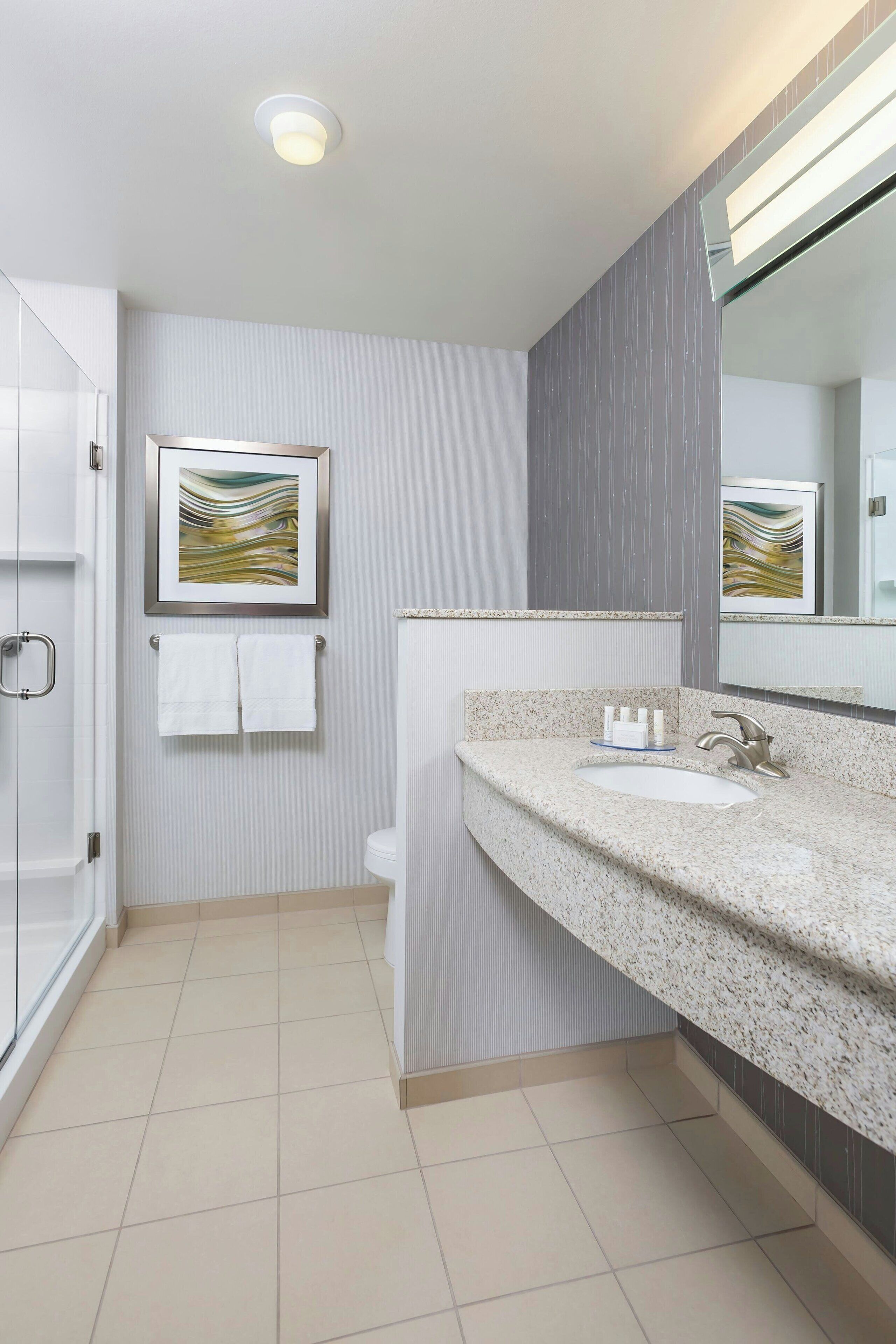 combined shower/bathtub, designer toiletries, hair dryer, towels