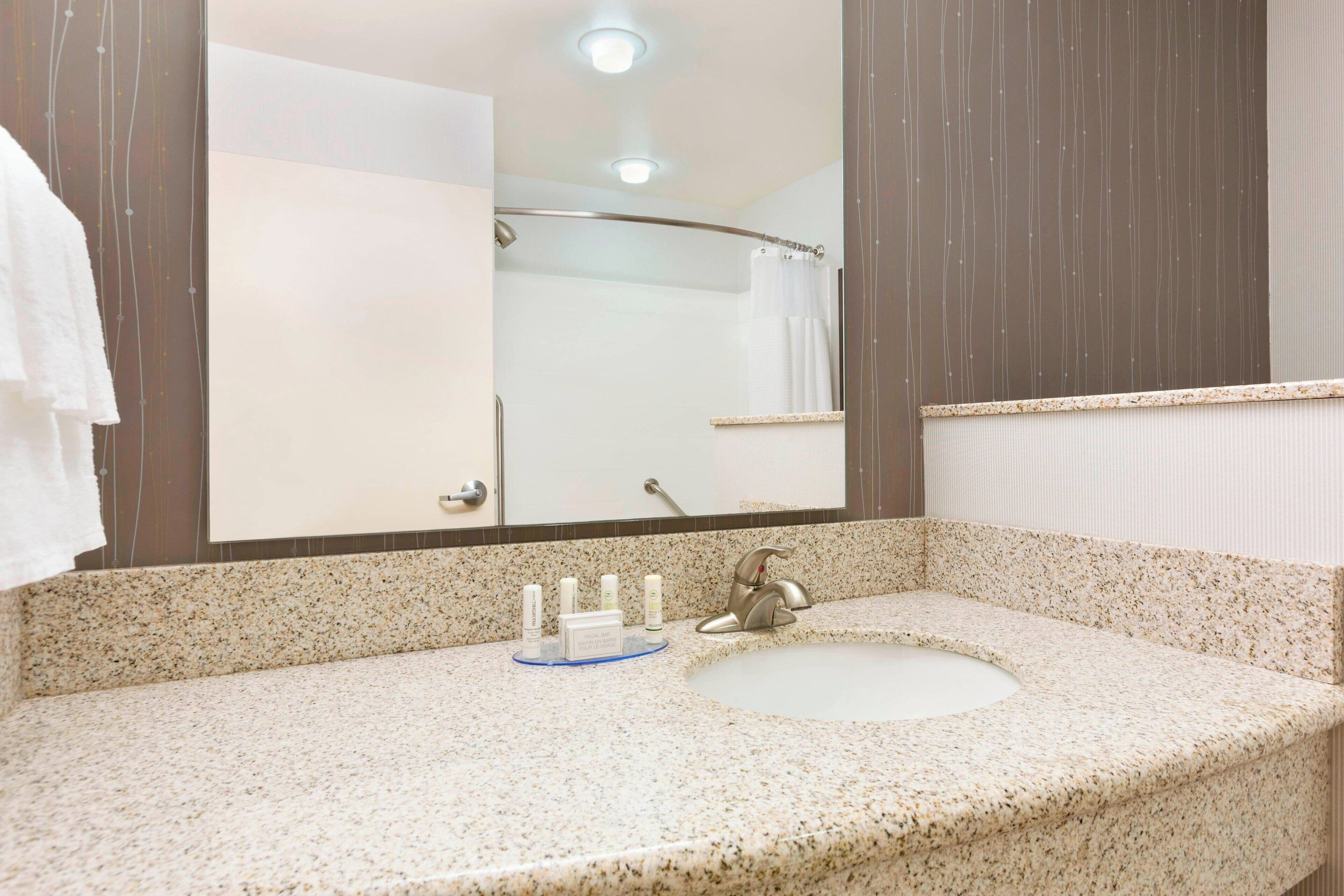 combined shower/bathtub, designer toiletries, hair dryer, towels