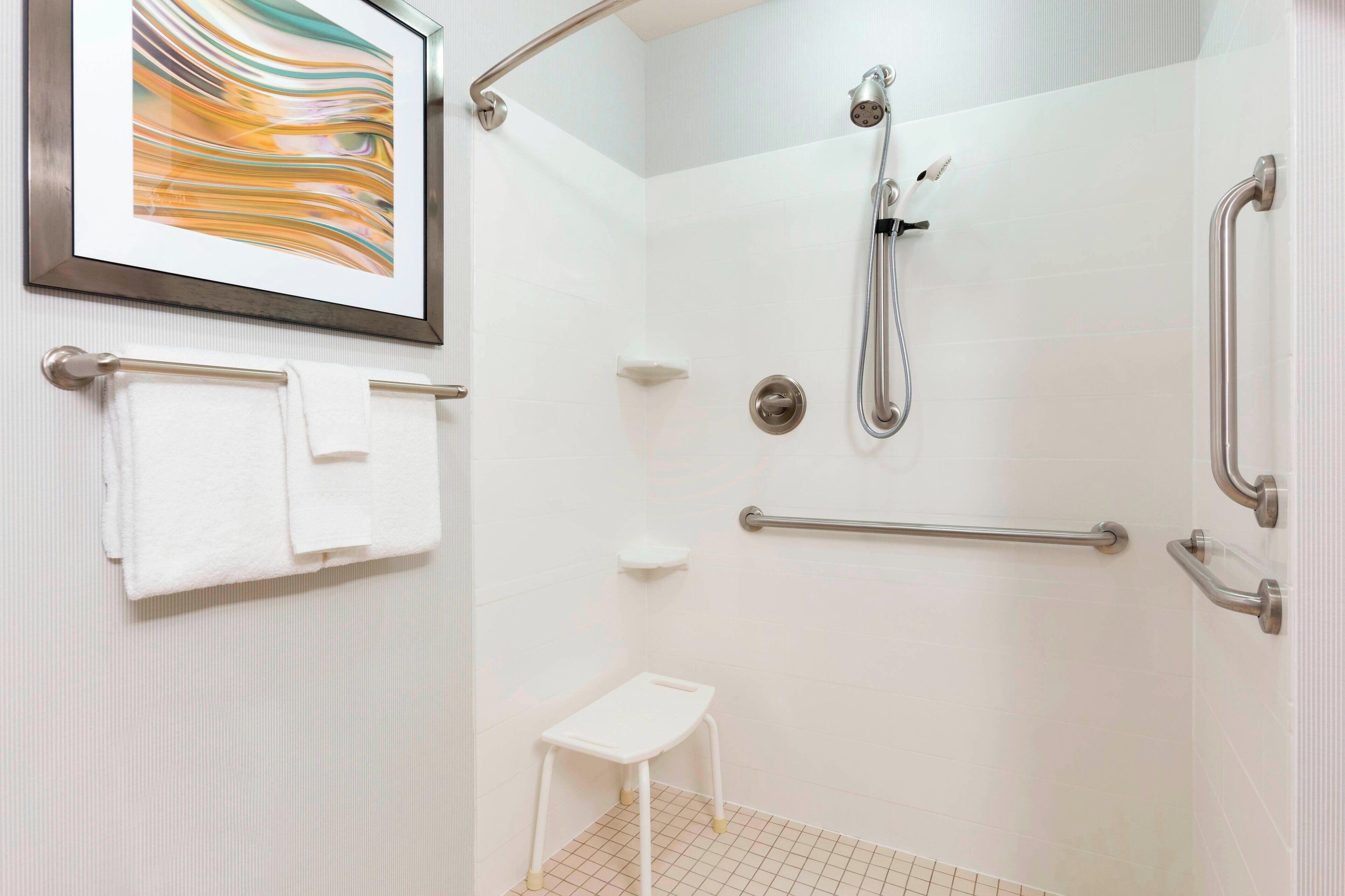 combined shower/bathtub, designer toiletries, hair dryer, towels