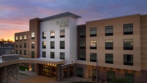 A Fairfield by Marriott hotel with a modern design, featuring multiple floors and a well-lit entrance.