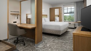 A hotel room with a bed, desk, chair, TV, and large windows. - SpringHill Suites Jackson North/Ridgeland (Ridgeland)