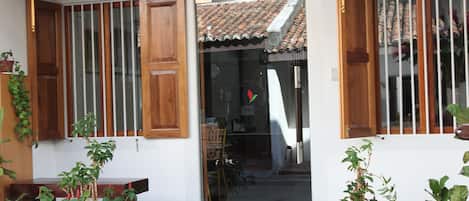 A hotel entrance with a sign reading "GINGERFLOWER BOUTIQUE HOTEL".
