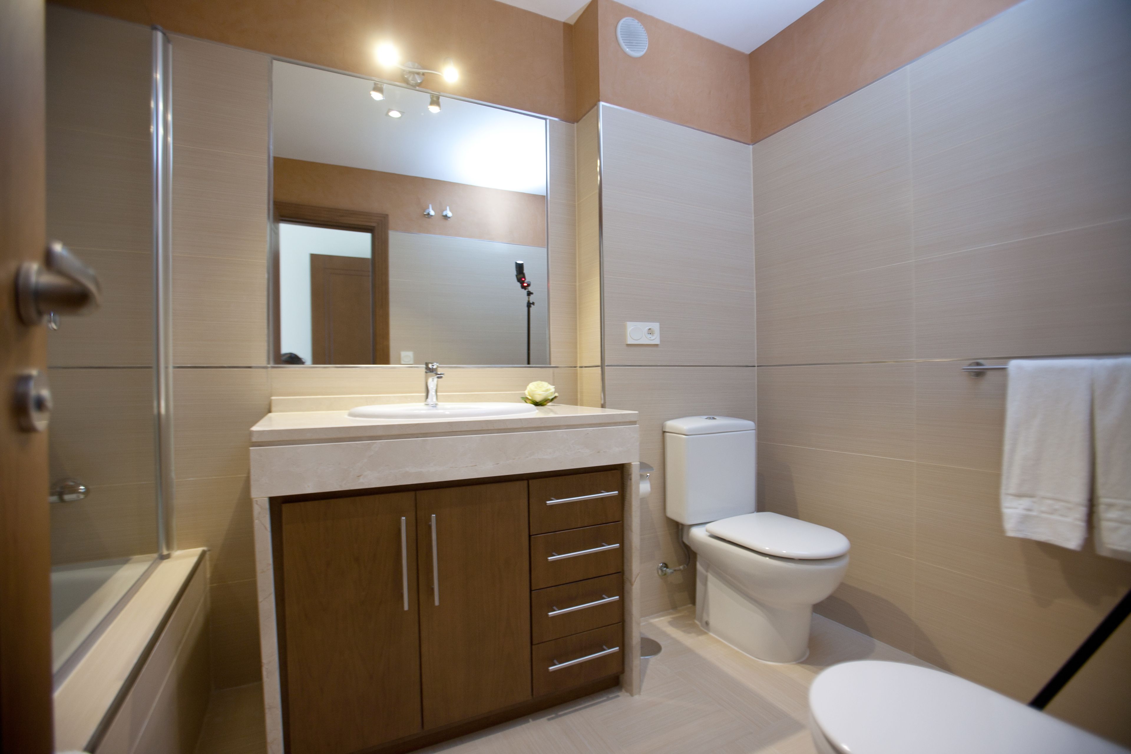 A modern bathroom with a bathtub, sink, and toilet.