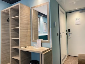 Enjoy a comfortable stay in this stylish room featuring a wardrobe, desk, and mirror.
