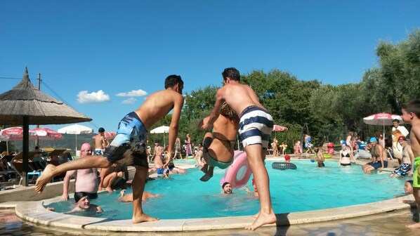 Seasonal outdoor pool, open 9:00 AM to 7:00 PM, pool umbrellas