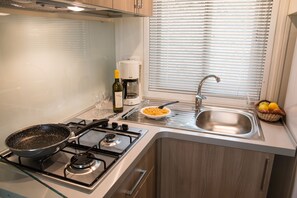Deluxe Mobile Home, 3 Bedrooms | Private kitchen | Full-sized fridge, high chair, cookware/dishes/utensils