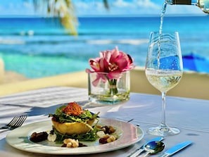 Enjoy a romantic meal with a view of the ocean from this outdoor dining area.