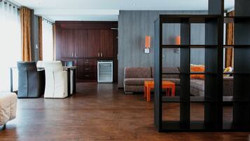Een moderne woonkamer met een bank, een salontafel, en een eetgedeelte met een tafel en stoelen.