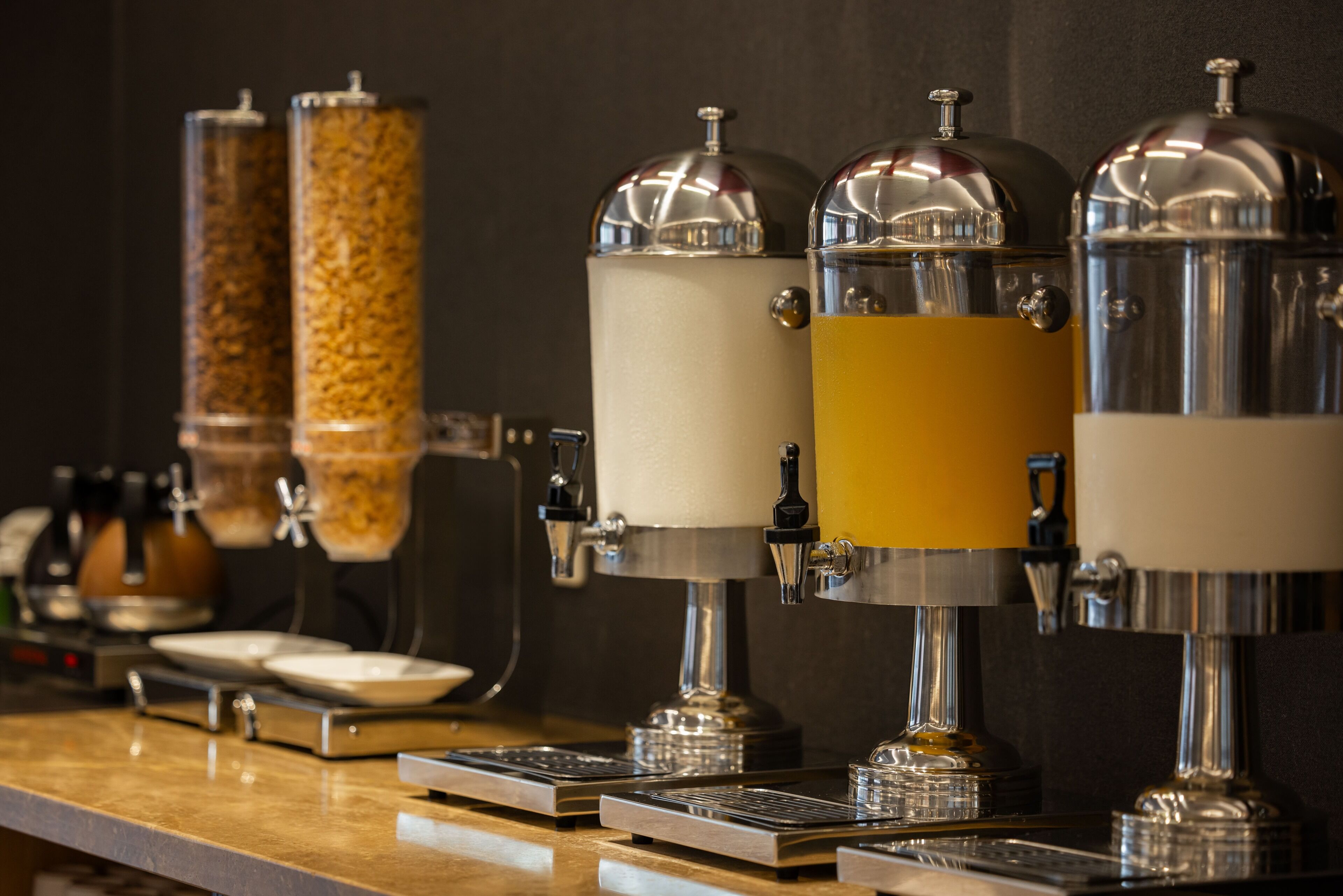 A coffee station with multiple dispensers and a coffee machine.