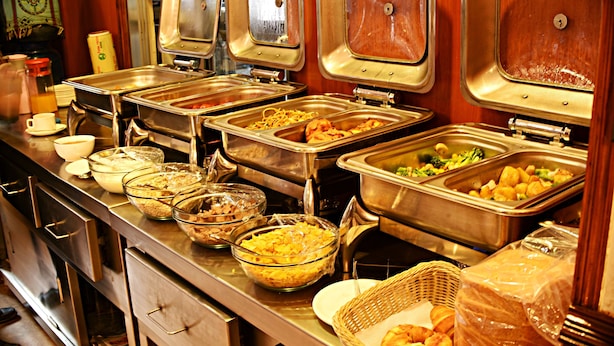A buffet with various food items and containers. - Hotel Friend's Home (Kathmandu)