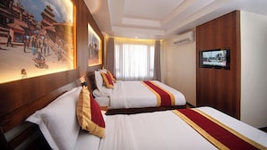 A hotel room with two beds, a TV, and a mural of a mountainous landscape. - Hotel Friend's Home (Kathmandu)