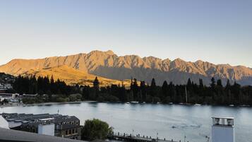 A mountain range with a lake in the foreground.