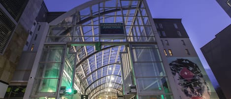 A modern building with a glass facade and a sign reading "JUNCTION WALK THRU."