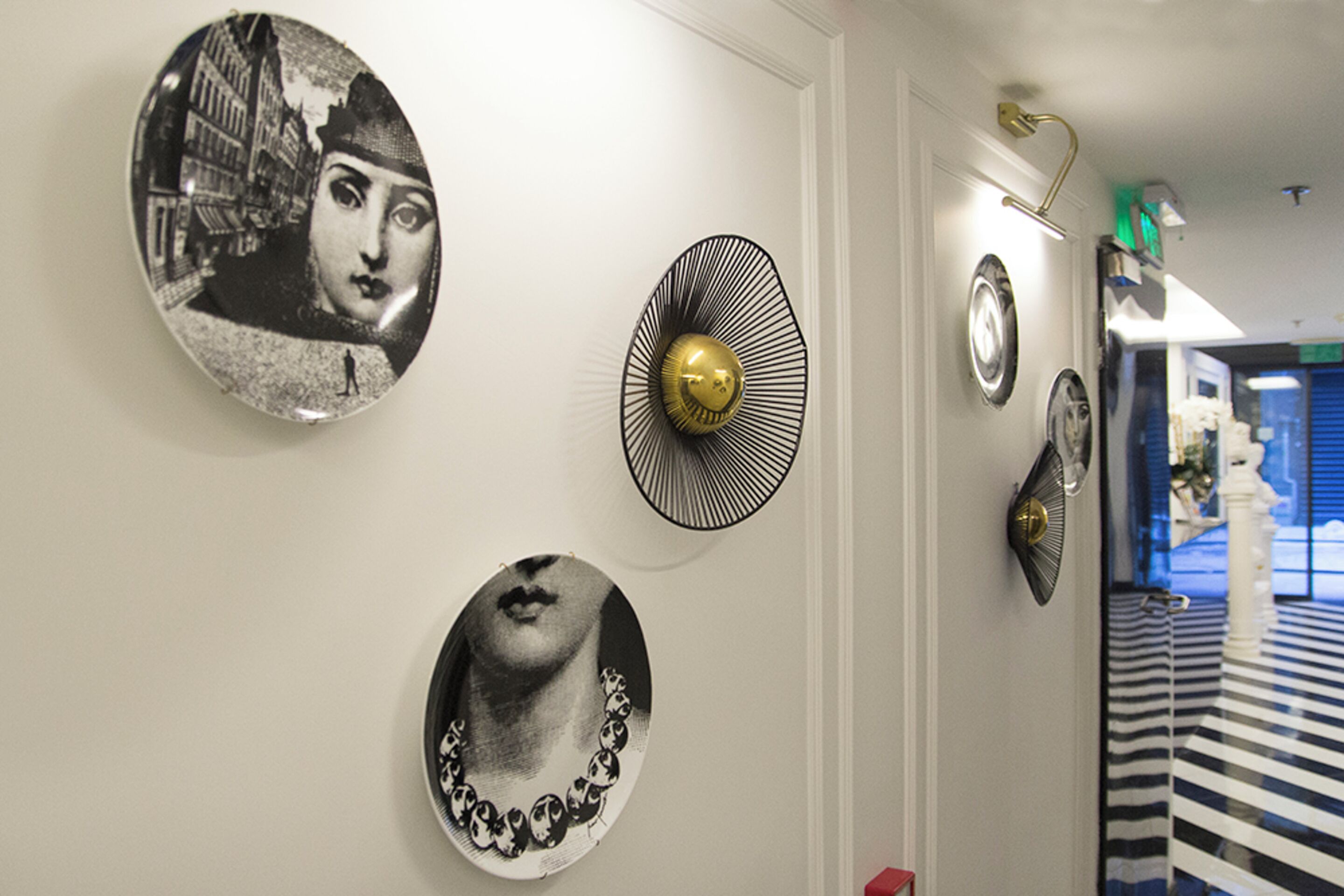 A hallway with decorative plates and a patterned floor.