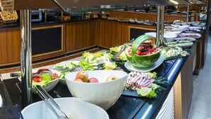 A buffet with various food items, including salads, fruits, and meats. - Aprilis Hotel - Special class (Istanbul)