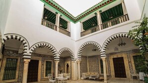 A courtyard with arches, columns, and a tiled floor. - Dar Ben Gacem (Tunis)