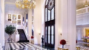 A grand lobby with a black and white checkered floor, a staircase, and a large clock. - The Ritz-Carlton, Tianjin (Tianjin)