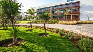 A modern building with a sign reading "Alhogueima Bay". - Hotel Souani (Ait Youssef Ou Ali)