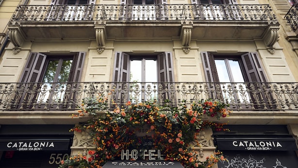 A hotel facade with ornate balconies, flower boxes, and signage for 'Catalonia Hotel Gran Via BCN'. - Catalonia Gran Vía BCN (Barcelona)