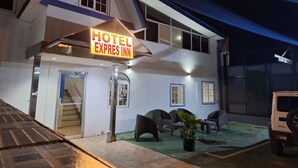 A two-story building with a sign reading "HOTEL EXPRESS INN". - Express Inn Panama International Airport Hostel (Tocumen)