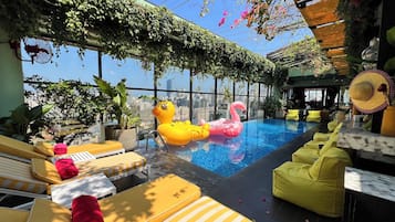 Outdoor pool, open 6:00 AM to 6:00 PM, pool loungers