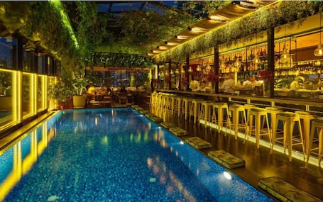 Outdoor pool, open 6:00 AM to 6:00 PM, pool loungers. The Smallville Hotel