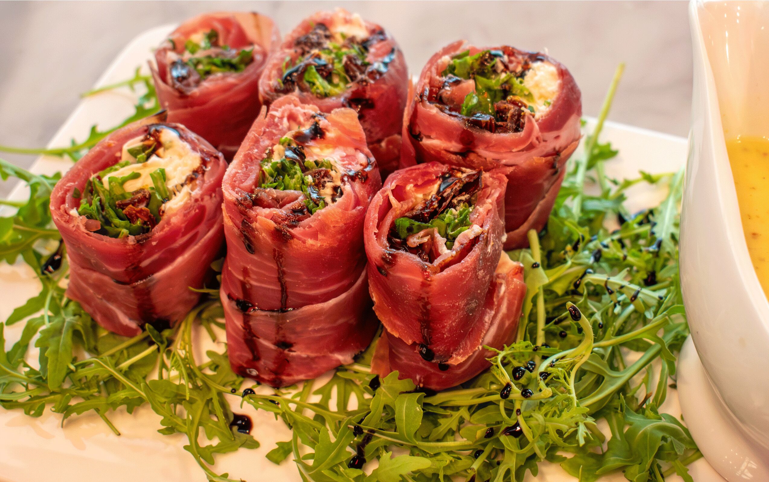 A plate of stuffed peppers with a garnish of greens.