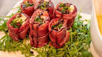 A plate of stuffed peppers with a garnish of greens.