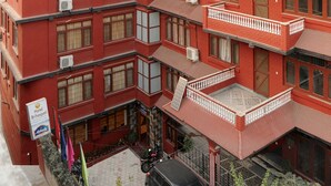 A multi-story hotel with balconies and air conditioning units. - Hotel Brihaspati (Kathmandu)