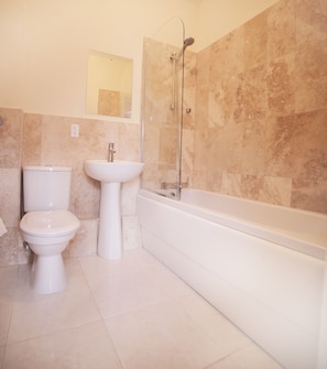 A bathroom with a toilet, sink, and bathtub. - Lantana Resort (Weston)