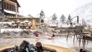 A hot spring area with stone seating and a fire pit. - Red River Inn Silt-Rifle (Silt)