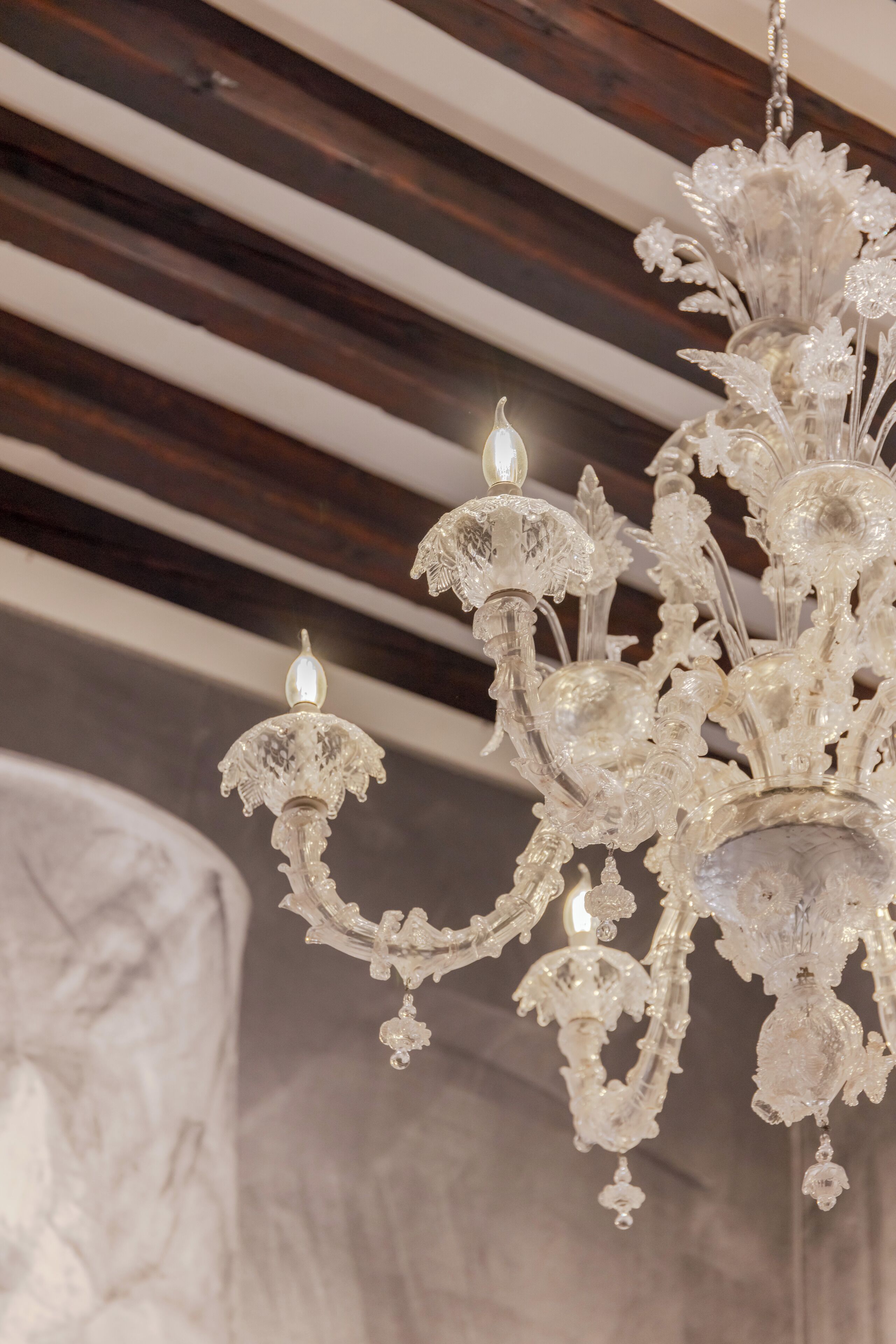 A chandelier with multiple crystal arms and lights.