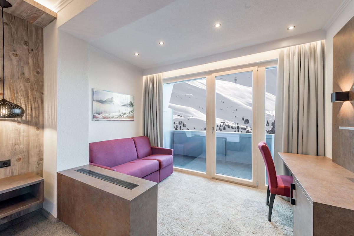 standard double room, balcony, mountain view | living area | flat-screen tv