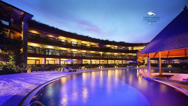 A hotel with a swimming pool, multiple balconies, and a covered area. - Uday Suites (Thiruvananthapuram)