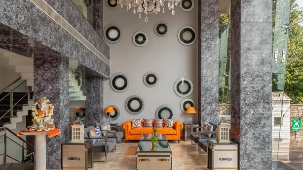 A spacious lobby with a grand chandelier, a statue, and a modern sofa arrangement. - Zone Connect by The Park Udaipur (Udaipur)