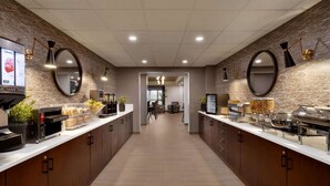 Una cocina moderna con una isla central, electrodomésticos integrados y una disposición tipo bufé.