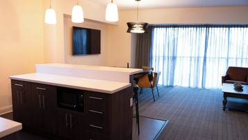 Desk, laptop workspace, blackout drapes, iron/ironing board