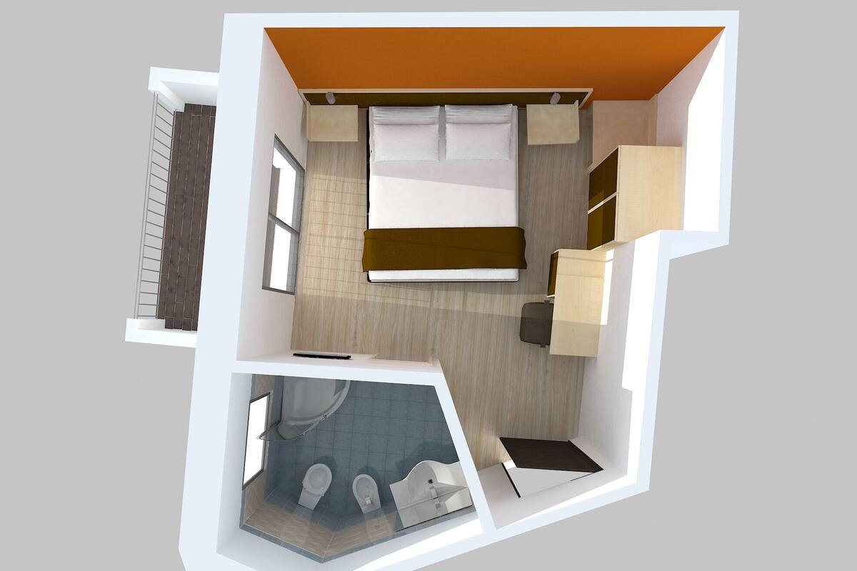 A 3D floor plan of a hotel room with a bed, a desk, a chair, a wardrobe, and a bathroom with a toilet and sink.